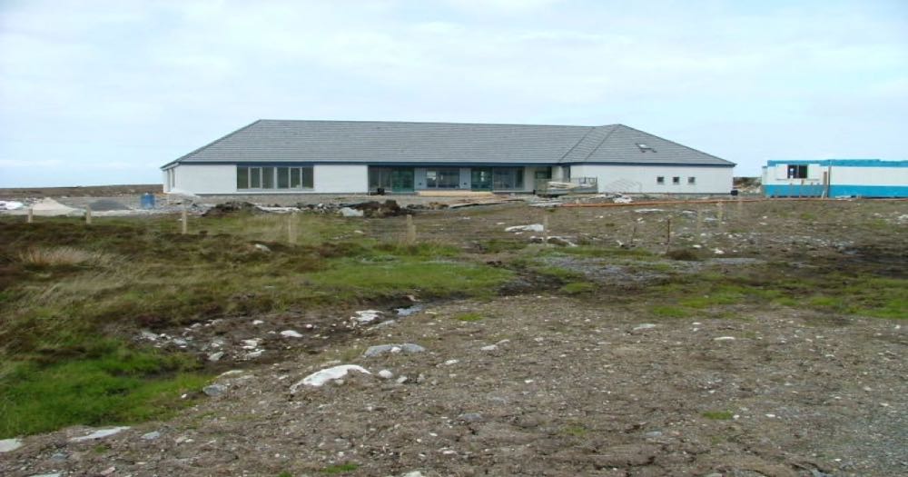 Building under construction with scaffolding, representing work in progress