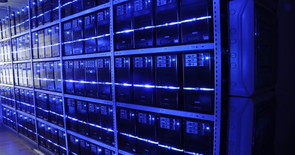 Rows of server racks in a data center, representing the physical infrastructure behind AI computation