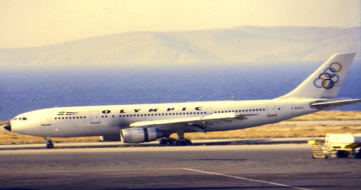A passenger jet parked on an airport apron under a cloudy sky, moments between landing and the terminal
