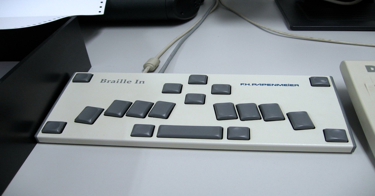 Close-up of a braille keyboard interface in a museum exhibit