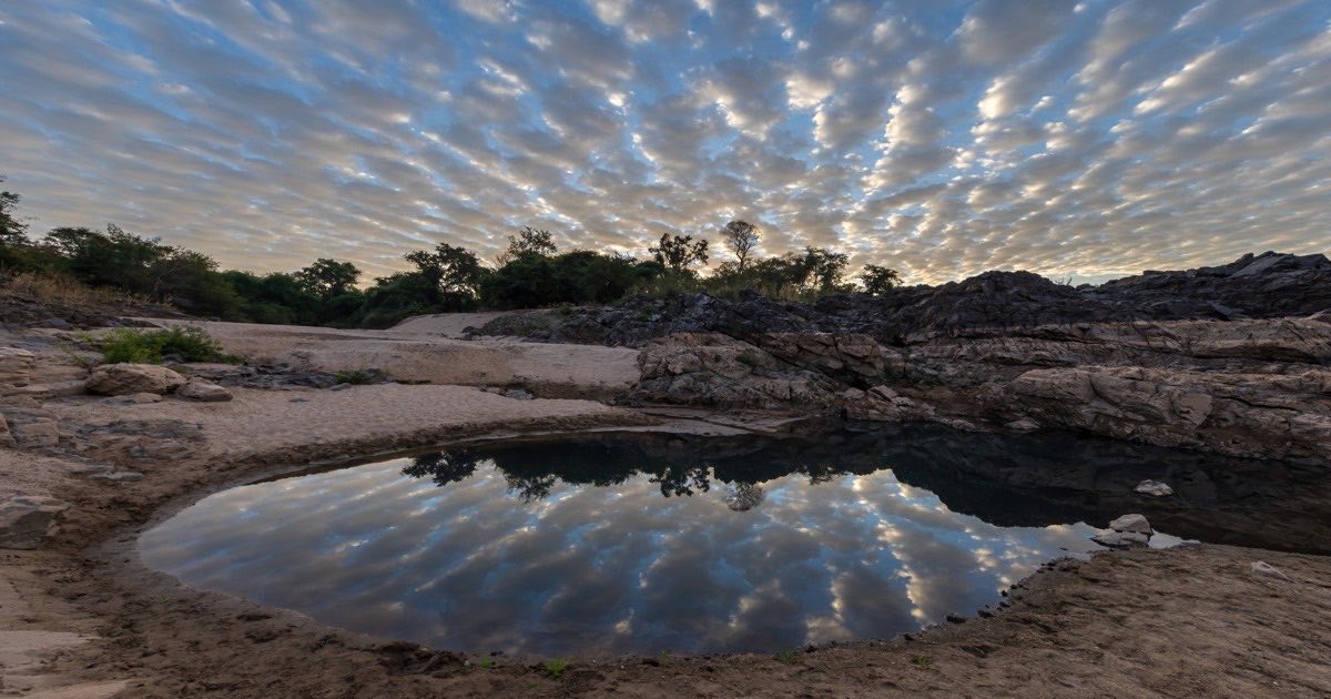 Soft clouds reflecting on water with subtle blue tint
